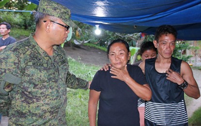 <div dir="auto"><strong>CONDOLENCES.</strong> Lt. Col. Francisco L. Molina, Jr., commander of the Army's 23rd Infantry Battalion, extends his condolences to Erlinda Cabatchete (center) the mother of Bertoldo Cabatchete Jr. and Bertoldo’s brother Roberto (right) on Sunday (Dec. 29, 2019). Cabatchete died of pneumonia and was abandoned by his New People's Army comrades in the hinterlands of Carranglan, Nueva Ecija last year.<em> (PNA photo by Alexander Lopez)</em></div>