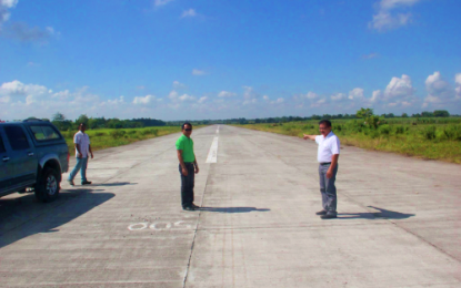 <p><strong>MOTHBALLED.</strong> Mindanao Development Authority Secretary Emmanuel Piñol (right) and his brother, Vice Mayor Lito Piñol (center) of M’lang, North Cotabato, show the runway of the mothballed Central Mindanao Airport, locally known as M’lang airport, to reporters following the visit of President Rodrigo Duterte in the province on Dec. 30, 2019. The President, after distributing relief and financial aid to thousands of recent quake victims from M’lang and other areas of the province, ordered for the immediate opening of the airport.<em> (Photo courtesy of MinDA Sec. Piñol)</em></p>