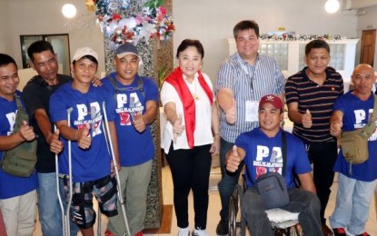 <p><strong>SUPPORT.</strong> Elections Commissioner Rowena Guanzon (center) and Silay City Mayor Mark Golez (3rd from right) with some of the national sitting volleyball players from Negros Occidental led by team captain Eric Molavin (in wheelchair) during their meeting in Bacolod City on Dec. 26, 2019. The 15-man team, mainly comprised of Negrenses, will compete in the 10th ASEAN Para Games hosted by the Philippines in March. <em>(Photo courtesy of Mayor Mark J. Golez Facebook page)</em></p>