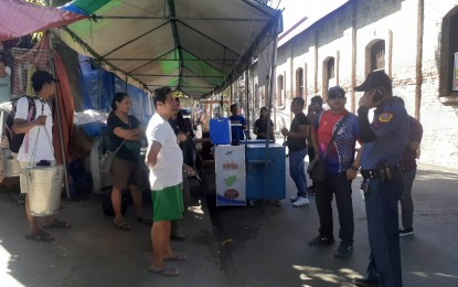 <p><strong>ROAD-CLEARING</strong>. Traffic enforcers resume road clearing operations along Gen. Segundo St. in Laoag City on Tuesday (Jan. 7, 2020). In the photo, a stall owner just across the Museo Iloco is ordered to clear the street of his merchandise. <em>(Photo courtesy of PNP Traffic Division)</em></p>