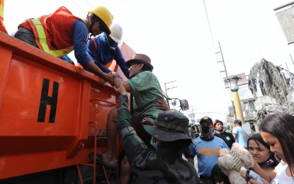 <p><strong>EVACUATION OPS.</strong> An elderly man is assisted in going up a DPWH truck as residents affected by the volcanic eruption move to safer grounds. To avoid hazards caused by the eruption, the Department of Health advised residents to remain indoors and to keep all windows and doors closed.  (PNA<em> photo by Joey Razon)</em></p>