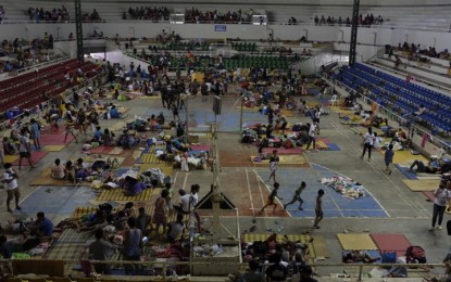 <p><strong>TAAL VOLCANO ERUPTION.</strong> Families eating and resting at the Batangas Sports Complex which now serves as an evacuation center for the displaced residents of the province. The National Disaster Risk Reduction and Management Council on Tuesday (Jan. 14, 2020) reported that a total of 9,527 families were affected by the Taal Volcano eruption on Sunday. <em>(Photo courtesy of LJ Pasion, Save the Children)</em></p>