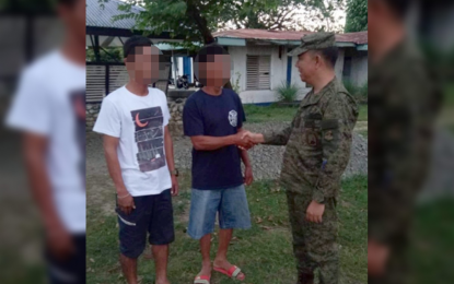 <p><strong>SURRENDERED</strong>. Lt. Col. Reandrew P. Rubio, commander of the 91st Infantry “Sinagtala” Battalion, Philippine Army, greets two members of the New People's Army who voluntarily surrendered to government troops in Barangay Tugatog, Bongabon, Nueva Ecija on Monday, Jan. 13, 2020. The two surrendered rebels said they decided to return to the fold of law due to the difficulties they experienced in the underground movement. <em>(Photo courtesy of the Army's 91st Infantry Battalion)</em></p>