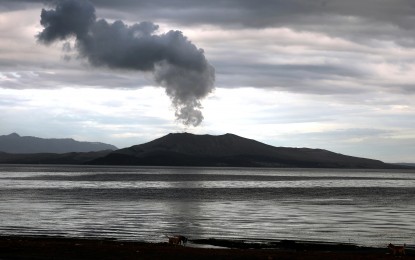 <p><strong>RESTIVE TAAL.</strong> Smoke billows out of Taal Volcano's crater as seen from the lakeshore in San Nicolas, Batangas. The volcano remains under alert level 4, meaning a hazardous explosive eruption is possible within hours or days. <em>(PNA photo by Joey Razon)</em></p>