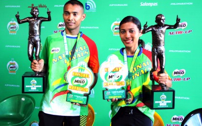 <p><strong>MARATHON CHAMPS.</strong> Jerald Zabala and Christine Hallasgo ruled the men's and women's divisions of the 42nd National Milo Marathon Finals in Tarlac City on Sunday (Jan. 19, 2020). The event marked the culmination of its 10-leg cycle with the theme, "One Team. One Nation. Go Philippines" in celebration of unity and support for the athletes who competed in the Southeast Asian Games last year.<em> (PNA photo by Jess M. Escaros Jr.)</em></p>