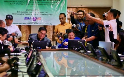 <p><strong>SEALED.</strong> Bangsamoro Autonomous Region in Muslim Mindanao executive secretary Abdulraof Macacua (left) and Susan Ople (right) sign a memorandum of agreement on Tuesday (Jan. 21) in Cotabato City for the creation of the Bangsamoro Task Force Against the Trafficking of Overseas Filipino Workers in the region. The creation of the task force aims to address the plight of migrant workers from the region who are victims of human trafficking.<em> (Photo courtesy of Noel Punzalan – PNA Cotabato)</em></p>