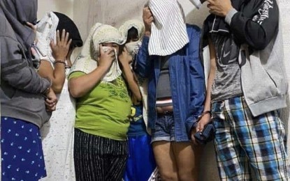 <p><strong>BUY-BUST.</strong> Six drug suspects cover their faces after their arrest in a buy-bust operation in Consolacion, Cebu on Monday (Jan. 20, 2020). Maj. Verniño Noserale, town police chief, said more than a kilogram of shabu was seized in the operation. <em>(Photo courtesy of Consolacion Police Station)</em></p>