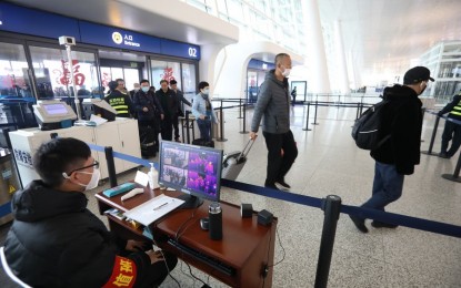 <p><strong>SAFETY MEASURE</strong>. Staff members take passengers' body temperature at Tianhe International Airport in Wuhan, capital of central China's Hubei Province, on Jan. 21, 2020. Malacañang on Thursday said there is no recommendation yet to bar visitors from Wuhan. (<em>Photo courtesy of Xinhua/Xiao Yijiu)</em></p>