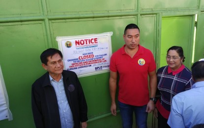 <p><strong>CLOSED.</strong> San Juan City Mayor Francis Zamora (right) and Environment Secretary Roy Cimatu (left) serve the closure order on the slaughterhouse of Megga Foods and Stock Farm Inc. in Barangay Kabayanan on Wednesday (Jan. 22, 2020). The establishment was ordered closed for its failure to secure environmental permits.<em> (PNA photo by Lloyd Caliwan)</em></p>