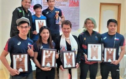 <p><strong>ANOTHER WINDFALL</strong>. Some of the medal-winning athletes in the South East Asian Games pose with their mentors at the University of the Cordilleras, former vice president for administration Leonarda Aguinalde (middle front) and sports director Danilo Cong-o (left, back row) during the KISLAP awards on Dec. 30, 2019 where they were honored. Some of them will receive their PHP25,000 Christmas bonus from the Philippine Sports Commission. <em>(PNA photo by Pigeon Lobien)</em></p>