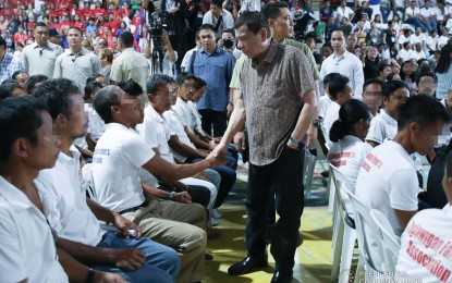 <p><strong>WELCOMING EX-REBELS.</strong> President Rodrigo Duterte greets former rebels before distributing their benefits during a ceremony at the San Isidro Civic Center in San Isidro, Leyte on Thursday (Jan. 23, 2020). The government will build a resettlement site with more than 400 houses and a considerable area for livelihood activities in San Isidro town for former rebels. <em>(Presidential photo by Karl Norman Alonzo)</em></p>