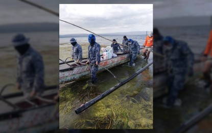 <p><strong>LOCKDOWN</strong>. Personnel of the Philippine Coast Guard removing a motorized banca from the Taal lakeshore after the Department of the Interior and Local Government (DILG) identified the coastline as a high-risk area and imposed "total lockdown" on Thursday (January 23). The PCG said its personnel has removed a total of 16 boats, which have been kept in a safe location and will be returned to its owners after Taal Volcano calms down. <em>(Photo courtesy of PCG)</em></p>