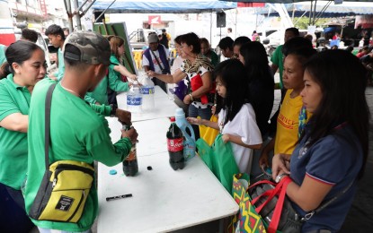 <p><strong>REFILL REVOLUTION</strong>. Residents of the City of San Fernando, Pampanga join the "Refill Revolution" on Friday (Jan. 24, 2020) by bringing recycled plastic bottles and containers and having these refilled with condiments and household products. The activity is an advocacy campaign of the Department of Environment and Natural Resources-Environmental Management Bureau (DENR-EMB) in Central Luzon aimed at beating plastic pollution by reducing its production and necessity. <em>(Photo courtesy of the City Government of San Fernando)</em></p>