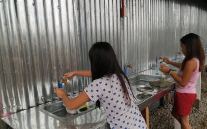 <p><strong>NEW LATRINES</strong>. Evacuees make use of the newly-built temporary latrines installed at the Sto. Tomas evacuation center. The temporary latrines would be replicated in other evacuation centers in Batangas. <em>(PNA photo by Lade Kabagani)</em></p>
