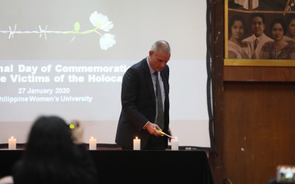 <p><strong>REMEMBERING HOLOCAUST.</strong> Israel Ambassador to the Philippines Rafael Harpaz lights a candle in a ceremony commemorating the victims of the Holocaust at the Philippine Women's University in Manila on Monday (Jan. 27, 2020). The event marks the International Holocaust Remembrance Day and the 75th anniversary since the liberation of the Auschwitz-Birkenau concentration camp. <em>(PNA photo by Avito Dalan)</em></p>