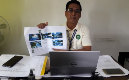 <p><strong>INFRA PROJECTS</strong>. Sofronio Raul Egargue, municipal engineer of Baler, Aurora, shows the plans and layouts of the various infrastructure projects that are seen to be completed in the town this year. The more than PHP500-million worth of infrastructures are expected to boost socio-economic development and promote the social well-being of the townsfolk. <em>(Photo by Jason de Asis)</em></p>