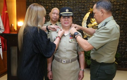 <p><strong>PH NAVY’S FIRST.</strong> AFP chief-of-staff Gen. Felimon Santos Jr. (right) leads the donning ceremony for Commodore Luzviminda Camacho, one of the AFP's newly-promoted senior officials, in Camp Aguinaldo on Tuesday (Jan. 28, 2020). Camacho made history as the first female Commodore (equivalent to Brigadier General or one-star rank in the Army, Air Force, and Marines) of the Philippine Navy. <em>(Photo courtesy of AFP Public Affairs Office)</em></p>
