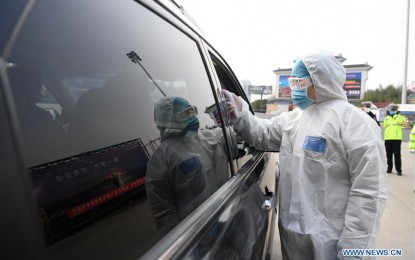 <p><strong>SAFETY MEASURES.</strong> A staff member measures temperatures of passengers at an expressway exit in Hefei, east China's Anhui Province, Jan. 29, 2020. Various measures are taken across China to combat the novel coronavirus. <em>(Xinhua/Liu Junxi)</em></p>