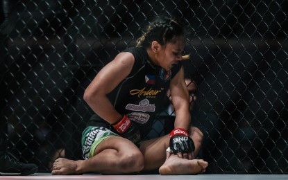 <p><strong>IN PAIN</strong>. Jomary Torres clutches her groin area after an unintentional low blow by Jenny Huang at One: Fire and Fury at the Mall of Asia Arena in Pasay City on Jan. 31, 2020. The fight was stopped and declared a no contest after Huang accidentally hit Torres' groin area twice. <em>(Photo courtesy of One Championship)</em></p>