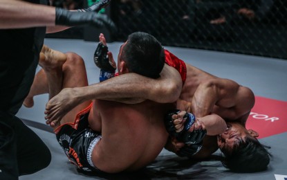 <p><strong>LOCKED</strong>. Lito Adiwang performs a Kimura lock on Pongsiri Mitsatit at ONE: Fire and Fury at the Mall of Asia Arena in Pasay City on Jan. 31, 2020. Adiwang walked away with a win via submission. <em>(Photo courtesy of ONE Championship)</em></p>