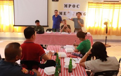 <p><strong>COMMITTED TO END INSURGENCY.</strong> Igbaras Mayor Jaime Esmeralda (extreme right, standing) holds high the resolution declaring the Communist Party of the Philippines-New People's Army (CPP-NPA) persona non-grata on Thursday (Jan. 30, 2020). Such declaration shows the local government's commitment to end insurgency, the Philippine Army said. <em>(Photo courtesy of Philippine Army's 61st Infantry Battalion)</em></p>