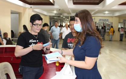 <p><strong>MEASURES VS. CORONAVIRUS</strong>. Executive Assistant IV Reina Manuel (right) of the city government of Angeles distributes face masks to all the front line offices at the city hall on Friday, Jan. 31, 2020. This is part of the safety measures for the prevention and protection of the locals against the spread of coronavirus in the city. <em>(Photo courtesy of the city government of Angeles)</em></p>