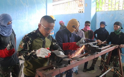 <p><strong>NEW SKILLS.</strong> A total of 15 government militiamen and five former communist rebels receive their certification for shielded metal arc welding (SMAW) training on Friday in Butuan City. The program is designed by the Army's 3rd Special Forces Battalion, with the support of other government agencies and the private sector. <em>(Photo courtesy of 3SFBn)</em></p>