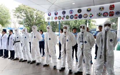 <p><strong>FIGHT VS. CORONAVIRUS.</strong> Chemical, biological, radiological, nuclear and explosives (CBRNE)-trained personnel of the Philippine National Police (PNP) from its health service unit are ready to assist other government agencies in the repatriation of Filipinos in China and other countries affected by the 2019 novel coronavirus. Some of the personnel who are ready for deployment don face masks and protective clothing during an event after the flag-raising ceremony at the PNP Headquarters in Camp Crame on Monday (Feb. 3, 2020). <em>(PNA photo by Joey O. Razon)</em></p>