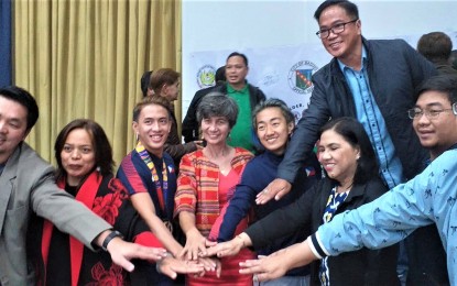 <p><strong>BAGUIO DENIZEN</strong>. A Baguio sports code is about to be completed by the city government that will not only look at the incentives of athletes and coaches but also provides continuous training that will professionalize and improve the concerned capabilities. The code will identify who are really Baguio athletes, says councilor Levy Lloyd Orcales (2nd right), seen here with Department of Education-Cordillera officials, athletes and city officials like city coordinator Gaudencio Gonzales (back), Southeast Asian Games gold medalist Jeordan Dominguez (3rd left), and Sandi Menchi Abahan (5th left). <em>(PNA photo by Pigeon Lobien)</em></p>