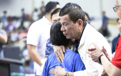 <p><strong>DUTERTE VISITS TAAL ERUPTION VICTIMS.</strong> President Rodrigo Duterte hugs one of the victims of the Taal Volcano eruption during his visit at the Batangas City Sports Coliseum on January 14, 2020. Duterte has approved the proposal to grant around 5,448 housing units to families residing within the seven-kilometer radius danger zone near the restive Taal Volcano. <em>(Presidential Photo)</em></p>
<div> </div>