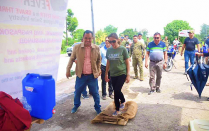 <p><strong>QUARANTINE PROCEDURE</strong>. North Cotabato Governor Nancy Catamco steps on the disinfectant board as part of preventive measures against the spread of the African Swine (ASF) Fever on the hog industry of the province. The provincial government, through its Task Force on ASF Prevention, have established quarantine stations in all access points of the province on Thursday (Feb. 6) as it also bars the entry of live hogs, pork meat and its by-products coming from ASF-infected areas of Mindanao and other parts of the country. <em>(Photo courtesy of North Cotabato PIO)</em></p>