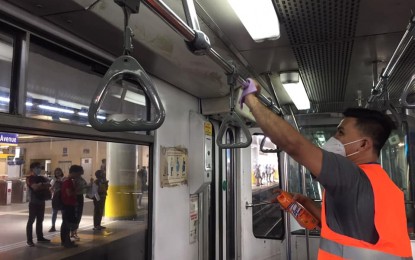 <p><strong>DISINFECTION.</strong> Personnel of Sumitomo-MHI-TESP, the MRT-3's maintenance provider, disinfects a handrail inside one of the Metro Rail Transit Line 3's (MRT-3) trains on Monday (Feb. 3, 2020). The MRT-3 management said the disinfection of its trains would continue so long as there is the threat of the 2019 novel coronavirus acute respiratory disease. <em>(Photo courtesy of MRT-3)</em></p>