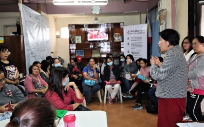 <p><strong>STRANDED</strong>. Overseas Workers Welfare Administration-Cordillera Administrative Region director Manuela Peña (far right standing) briefs the overseas Filipino workers who trooped to their office to avail of the PHP10,000 financial aid of the government. They were supposed to fly back to Macau Feb. 2 to 10 but were stranded due to the travel ban as a precautionary measure against the novel coronavirus threat. <em>(PNA photo by Zedrick John Macario)</em></p>