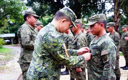 <p><strong>PROMOTED.</strong> Lt. Col. Warren C. Munda, commander of the Army's 75th Infantry Battalion, leads the donning of ranks to newly-promoted 59 enlisted personnel in a ceremony held at Camp Jaime N. Ferrer Sr. in Barangay Maharlika, Bislig City, Surigao del Sur on Monday (Feb. 10, 2020). Munda reminded the newly-promoted personnel that their ranks come with greater responsibility. <em>(Photo courtesy of 75IB)</em></p>