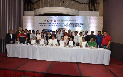 <p><strong>HOSPITAL FOR OFWS.</strong> Department of Labor and Employment (DOLE) Secretary Silvestre Bello III (seated, center) leads the signing of a memorandum of understanding for the construction of a hospital for overseas Filipino workers (OFWs) in Barangay Sindalan, City of San Fernando, Pampanga on Wednesday (Feb. 12, 2020). The project will solely cater to the medical needs of the OFWs in Pampanga and their families. <em>(Photo courtesy of Pampanga provincial government)</em></p>
