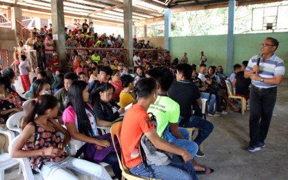 <p><strong>COUNTERING NPA RECRUITMENT.</strong> Lt. Col. Francisco Molina, Jr. (standing, front), commander of the Army's 23rd Infantry Battalion, leads an information drive against the recruitment of the New People’s Army in Barangay Manoligao, Carmen, Agusan del Norte on Wednesday (Feb. 12, 2020). The activity was participated in by 160 students in the village.<em> (PNA photo by Alexander Lopez)</em></p>
