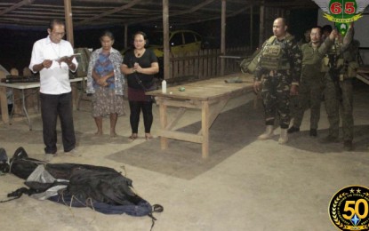 <p><strong>NPA LOSING GROUND.</strong> The cadaver of a suspected fighter of the New People's Army (NPA) is being blessed by a local clergyman as barangay and military officials look on. The fighter was killed in an encounter with the Army's 65th Infantry Battalion on Wednesday, February 12, in an upland village in Cagayan de Oro City. <em>(Photo courtesy of 4ID)</em></p>