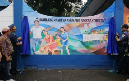 <p><strong>WALL OF PEACE.</strong> Brig. Gen. Filmore Escobal, Police Regional Office in Region 11 director (left) and  Col. Kirby John Kraft, Davao City Police Office director (right), unveil the 'Wall of Peace' on Friday (February 14). The murals depict images showing the atrocities of the New People's Army. <em>(PNA photo by Che Palicte)</em></p>