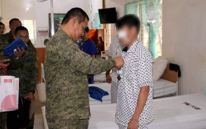 <p><strong>WOUNDED PERSONNEL AWARD.</strong> Brigadier General Gene Ponio, Commanding General of the 1st Infantry "Tabak" Division of Philippine Army, pins the Wounded Personnel Medal on one of the five wounded military troopers confined inside the 1ID army hospital on Monday (Feb. 17, 2020). Five soldiers were wounded and one was killed in the military operations February 15 in the hinterlands between Balindong and Piagapo towns in Lanao del Sur. <em>(Photo courtesy of 1ID)</em></p>