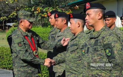 <p><strong>CURBING THREATS.</strong> Philippine Army (PA) commander, Lt. Gen. Gilbert Gapay (left) shakes hands with a member of the First Scout Ranger Regiment (FSSR) during his visit to its headquarters in Camp Tecson, San Miguel, Bulacan on Tuesday (Feb. 19, 2020). Gapay urged FSSR officers and enlisted personnel to remain aggressive in curbing terrorist groups.<em> (Photo courtesy of Army Chief Public Affairs Office)</em></p>