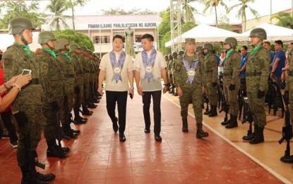 <p><strong>AURORA DAY</strong>. Rep. Rommel Rico T. Angara, (center) acting Governor Christian M. Noveras (left) and Lt. Col. Reandrew P. Rubio (right), commander of the Philippine Army's 91st Infantry Battalion, lead the 41st Foundation Day celebration of Aurora province and the 132nd birth anniversary of the late former First Lady Doña Aurora Aragon-Quezon. The event was held at the provincial capitol compound in Baler, Aurora on Wednesday, Feb. 19, 2020. <em>(Photo by Jason de Asis)</em></p>