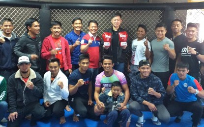 <p><strong>HOME FOR TEAM LAKAY</strong>. Benguet caretaker-congressman and ACT-CIS Party-list Rep. Eric Go Yap (6th from left, standing) poses with Team Lakay members at the team’s gym in Pico, La Trinidad, Benguet on Thursday to discuss means to give the team its own gym. Also in the photo are (from left) Brave champion Stephen Loman, former ONE champions Kevin Belingon, Geje Eustaquio and Eduard Folayang (4th from left, standing), head coach Mark Sangiao (5th from left, standing). <em>(PNA Photo by Pigeon Lobien)</em></p>