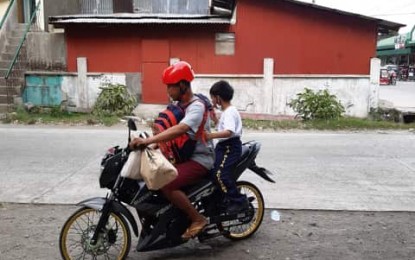 <p><strong>MOTORCYCLES AS PUBLIC CONVEYANCE.</strong> A man and a boy on board a motorcycle. The Antique Provincial Board on Thursday (Feb. 20, 2020) approves a resolution requesting the Department of Transportation and Land Transportation Office to register motorcycles as public conveyance. <em>(PNA photo by Annabel Consuelo Petinglay)</em></p>