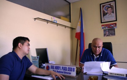 <p><strong>ROAD SAFETY.</strong> Land Transportation Office (LTO) 13 (Caraga) director Nordy L. Plaza (right) and operations chief Urbano Maglines Jr. check the data on the increase in revenue collection of the agency during the first month of 2020 on Thursday (Feb. 20, 2020). The increase was attributed to the intensified implementation of the “Balik Rehistro” program, a local initiative that aims to emphasize the mandate of the LTO to eradicate unregistered vehicles and unlicensed drivers.<em> (PNA photo by Alexander Lopez)</em></p>