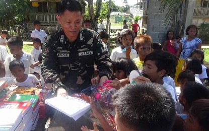 <p><strong>OUTREACH PROGRAM.</strong> A soldier joins a gift-giving activity in a school in Las Navas, Northern Samar. The Philippine Army said on Friday (Feb. 21, 2020) that the New People's Army is lying when it claimed that soldiers have been using schools in the Samar provinces as a “waiting area” during their operations against the communist terrorist group. <em>(Photo courtesy of Philippine Army)</em></p>
