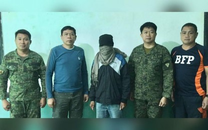 <p><strong>ANOTHER SURRENDERER.</strong> Alias "Cardo" (middle) surrenders to the Philippine Army's 61st Infantry Batallion (61IB) on Saturday (Feb. 22, 2020). “Cardo”, 49, of Tubungan town is considered a high ranking member of the Communist Party of the Philippines-New People’s Army (CPP-NPA). <em>(PNA Photo by Army's 61IB)</em></p>