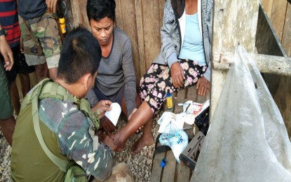 <p><strong>NPA VICTIM.</strong> A soldier from the Army's 3rd Special Forces Battalion provides first aid to one of the three civilians wounded when the communist New People’s Army fired an M203 grenade launcher in Sitio Emerald, Barangay Diatagon, Lianga town, Surigao del Sur on February 21, 2020. Army officials and tribal leaders denounced the attack. <em>(Photo courtesy of the Army's 3rdSpecial Forces Battalion)</em></p>