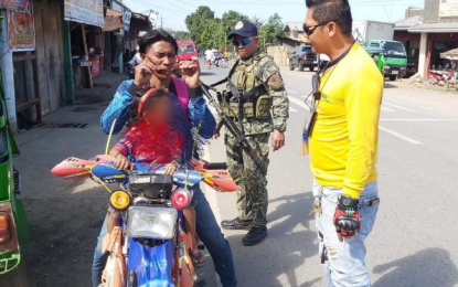 <p><strong>CHECKPOINT INSPECTION.</strong> A police officer and a traffic enforcer in Magpet town, North Cotabato, inspect a motorist on the national highway as part of security measures against criminal elements. The heightened security measure came after police arrested a suspected communist guerilla and top drug personality of Alamada town in the same province on Monday (Feb. 24, 2020). <em>(Photo courtesy of Magpet MPS)</em></p>