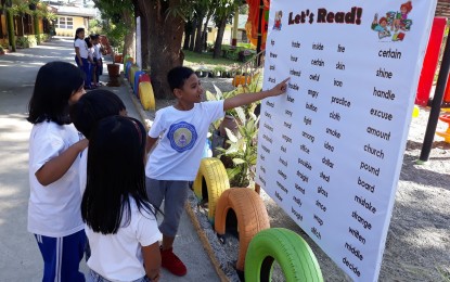 <p><strong>LOVE FOR READING.</strong> Pupils of Filipinas East Elementary School in San Nicolas, Ilocos Norte stand by at the newly-installed reading corners near the school park on February 21. Under DepEd Memorandum 173, series of 2019, the education department encourages offices from central to division levels and schools to intensify their advocacy for reading and make every learner a reader at their grade level and turn teachers into effective reading instructors.<em> (Photo courtesy of Orlando Pascua)</em></p>