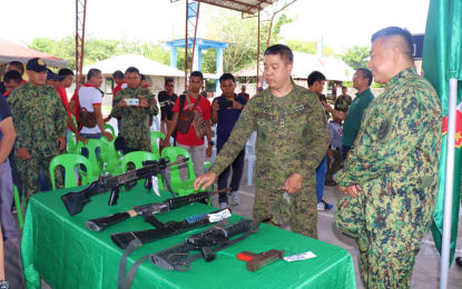 <p><strong>SURRENDERED FIREARMS.</strong> Army Col. Jose Narciso, (center), commander of the Army’s 601st Infantry Brigade, inspects the firearms surrendered on Monday (Feb. 24, 2020) by former drug personalities after they decided to live normal lives and avail of government’s livelihood assistance in exchange for their surrendered firearms during ceremonies held at Rajah Buayan, Maguindanao. Col. Arnold Santiago (right), Maguindanao police director looks on. <em>(Photo courtesy of 33IB)</em></p>